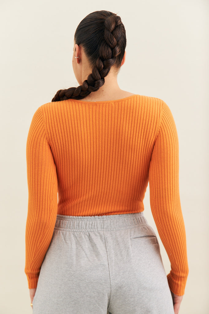 rib knit long sleeve orange body suit made by noon