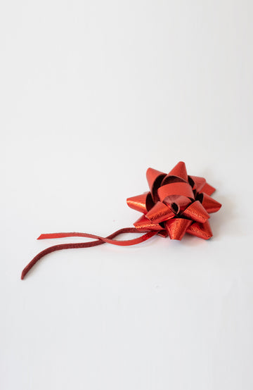 hand made leather bow to hang on your bag